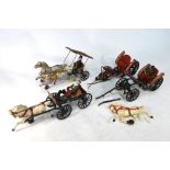 Four various cold-painted metal model horse-drawn carriages