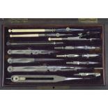 An Edwardian period mahogany-cased set of drawing instruments in nickel,