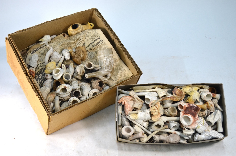 A substantial collection of clay pipes, modelled with heads, historical figures,