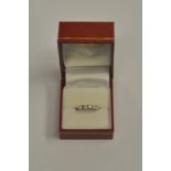 A five stone brilliant cut diamond set ring, white metal set, stamped 750, size J 1/2,