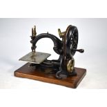 A Willcox Gibb 1883 patent hand sewing machine on hardwood base mount,