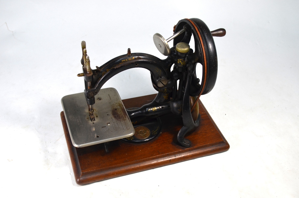 Willcox & Gibb hand sewing machine on hardwood base mount,