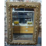 A late 19th century gilt and composite framed wall mirror,