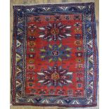 An antique Caucasian Kazak rug, the triple diamond design on red ground,