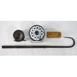 An antique brass 2-1/4in fly reel with ebonised handle,