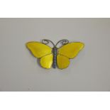 A Norwegian white metal and enamel butterfly brooch, with pale yellow enamel outstretched wings,