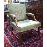 A George IV mahogany framed 'Gainsborough' chair with needlepoint covers,