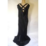 A 1930s bias-cut and inset black silk satin evening dress with draped hem,