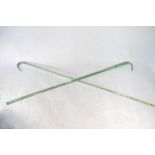 A 19th century plain glass walking cane, 99 cm long to/w a plain spiral twisted cane, 104.