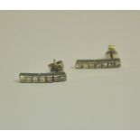 A pair of princess cut diamond set drop earrings, in white metal hinge settings, for pierced ears,