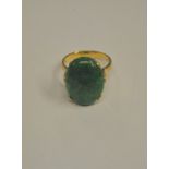 A single stone ring set oval jade cabochon, in high four claw yellow metal setting stamped 9ct,