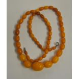 A single row of graduated reconstituted amber, of mixed shading, approx 2 oz,