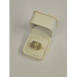 A seven row diamond set ring set with small eight cut diamonds, white gold setting stamped 750,