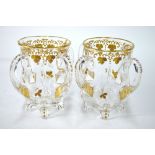 A pair of French glass celery jars with four handles raised on four feet,
