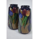 A pair of Royal Stanleyware 'Jacobean' tall vases decorated with tulips on a dark blue ground, 30.