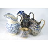 Four 19th century underglaze blue sponge decorated jugs, 10, 19,