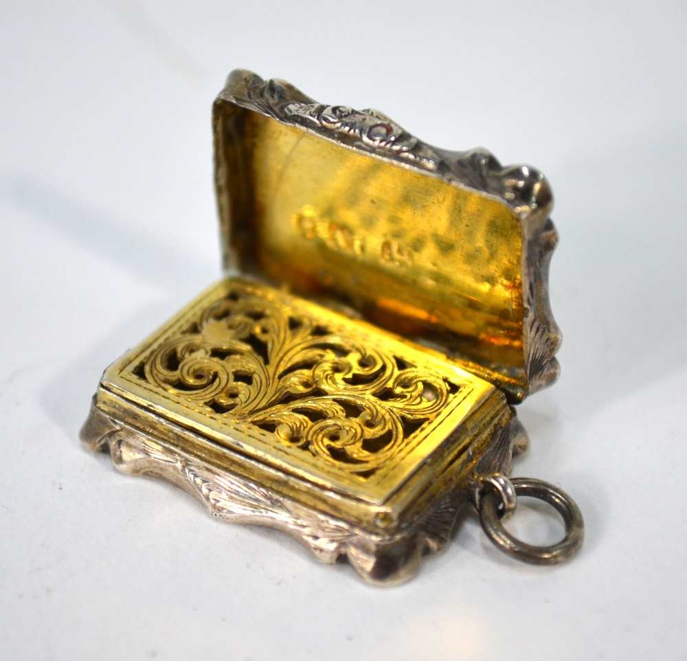 A Victorian foliate-engraved silver fob vinaigrette, the gilt interior with pierced grille,