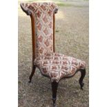 A Victorian walnut framed prie-dieu chair with fabric upholstery