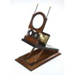 A Victorian stereo graphoscope of typical rectangular and folding form with central magnifying