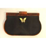 A vintage tortoiseshell effect Lucite clutch bag with enamelled and paste set butterfly to front,