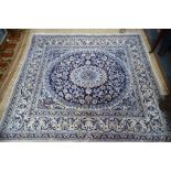 A Persian Nain carpet, blue & off-white ground with floral vine design overall,