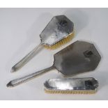 An engine-turned three-piece brush set with hand-mirror, in the Art Deco style,