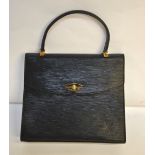 A vintage Louis Vuitton black epi grenelle leather handbag with suede lined inner zipped section,