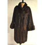 A dark brown shadowed mink fur coat with neat collar and cuffed sleeves retailed by Victor Seagall