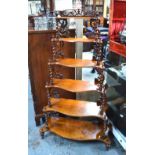 A Victorian graduated six-tier mahogany whatnot of serpentine form,