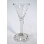 An 18th century cordial glass, drawn trumpet bowl, plain stem incorporating a tear drop,