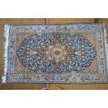 A Persian Hereke part silk rug,