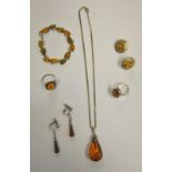 A selection of contemporary jewellery set with pressed amber including two oval rings, pendant,