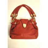 An Aspinal of London red grained leather handbag with gilded metal chain and leather strap and