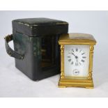 A French miniature brass cased travel alarm clock, striking on a bell, in green leather case,