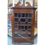 A George III mahogany hanging corner cupboard,