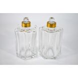 A pair of 20th century Baccarat Crystal cologne bottles with gilt metal stoppers and facetted