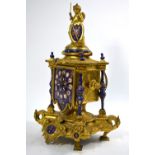 A 19th century gilt metal mantel clock in the Baroque manner, surmounted by a cherub,