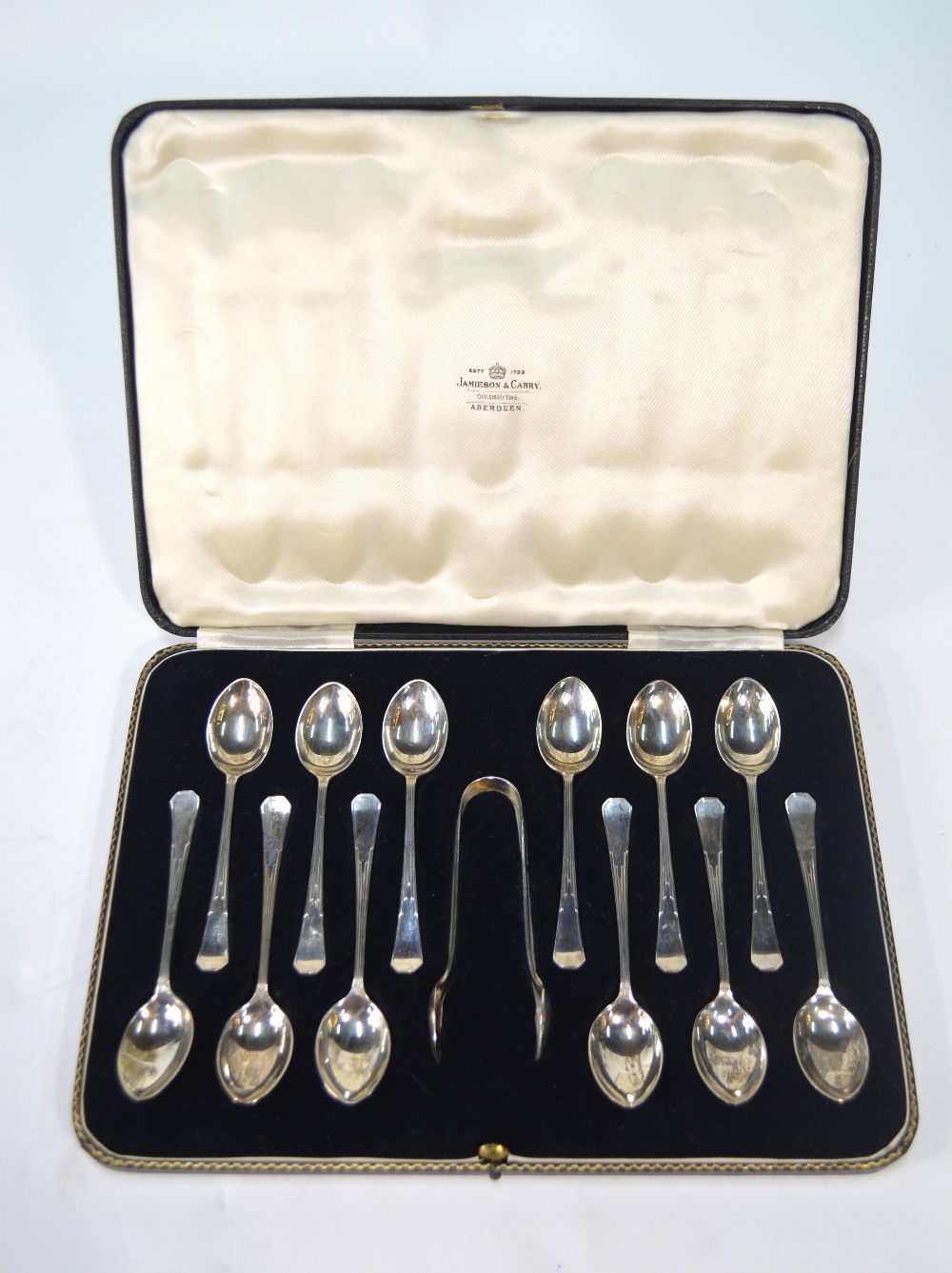 A cased set of twelve silver teaspoons and tongs in the Art Deco manner, Lee & Wigfull,