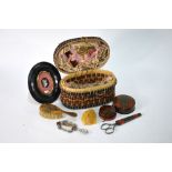 A doll's travelling toilette basket and contents,