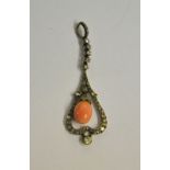 An Art Nouveau drop style pendant having pink conch pearl suspended within diamond set inverted