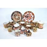 A small collection of Derby Imari decorated wares including two cups and a plate with red painted