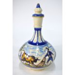 A 19th century Spanish faience bottle vase and stopper, painted with a bull, bull fighter, house,