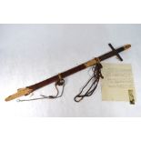 A 19th century Islamic sword, the 79cm blade engraved with Koranic prayer,