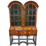 An antique walnut double dome top cabinet in the William & Mary style, in two parts,
