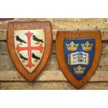 Two painted plaster armorial shields on oak plaques,