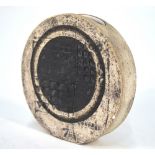 A small Troika wheel vase, beige textured surface with a black geometric circular design,