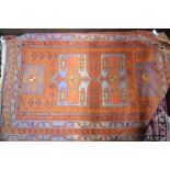 An old Caucasian Turkoman design rug, the geometric orange-red design on mixed blue-grey ground,