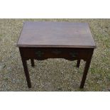 An 18th century oak side table with frieze drawer, raised on chamfered square section legs,