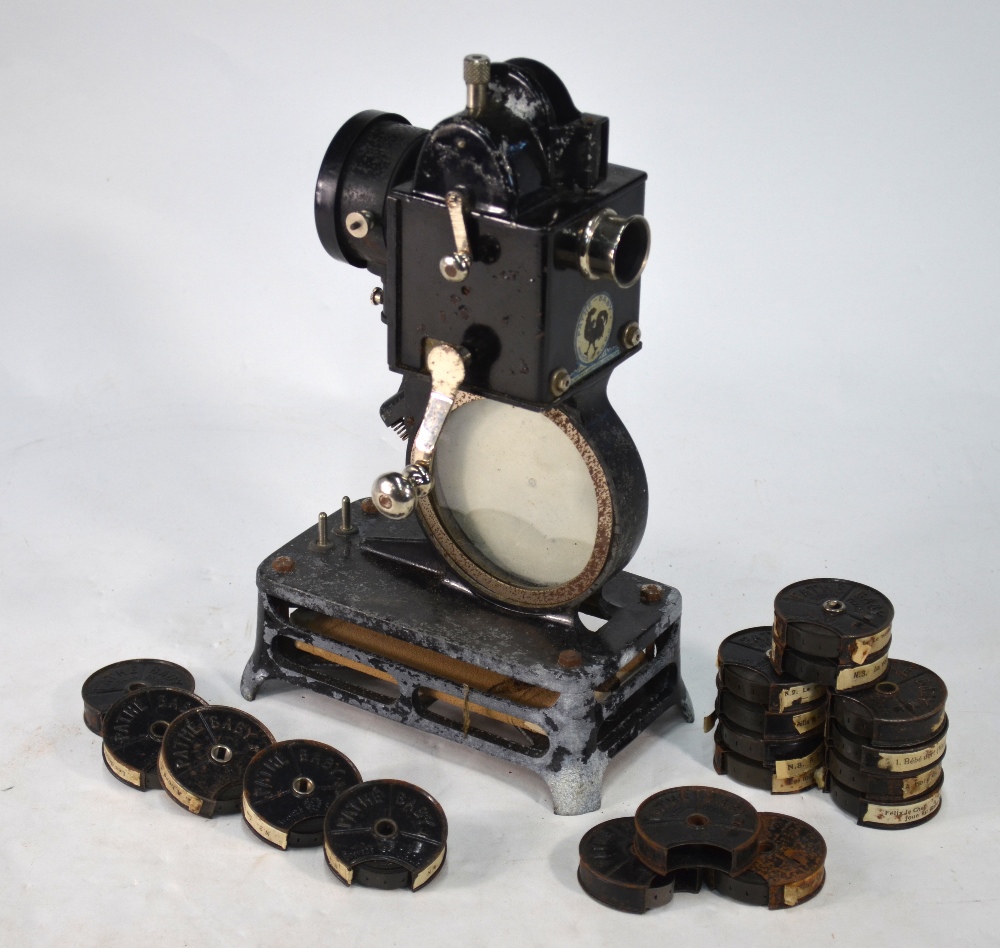 A French Pathe-Baby hand-cranked film projector, to/w a collection of film reels,