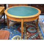 A circular mahogany centre table with inset green leather top,